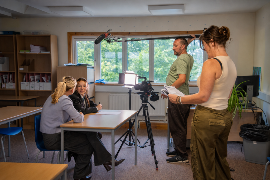 Athena Productions crew filming an interview on location