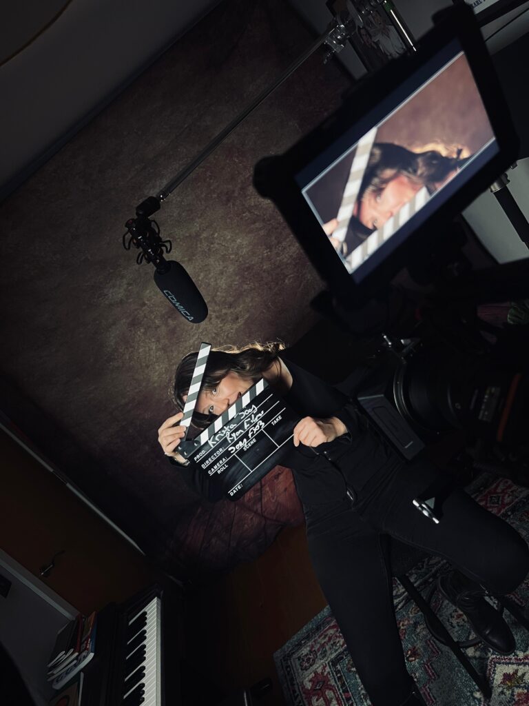 Krista Jay, Founder and Producer of Athena Productions on set with film equipment